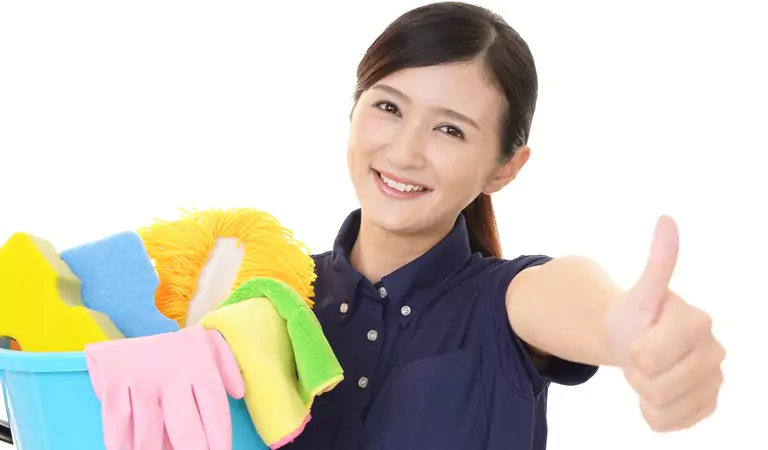 woman is ready to clean with some cleaning essentials