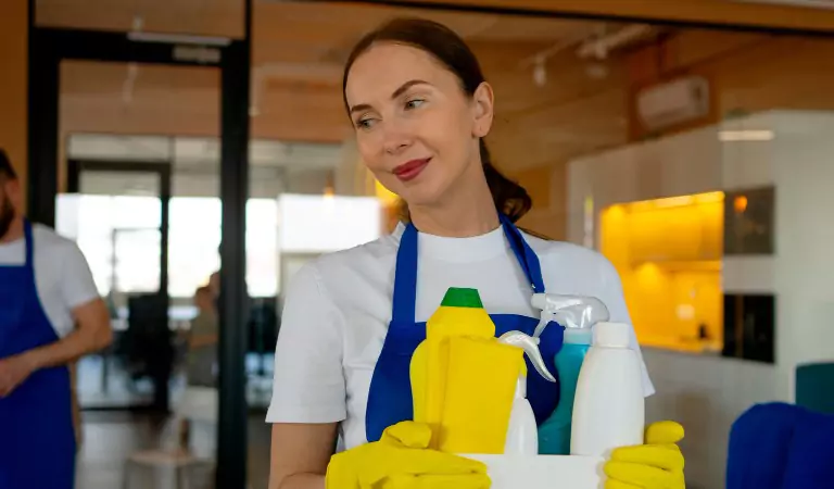 young professional with some cleaning essentials ready to clean
