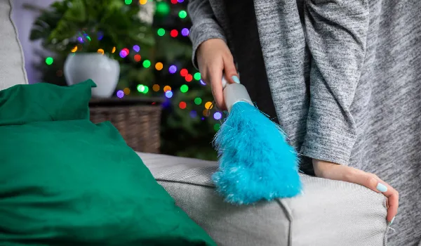 Woman cleaning sofa and lightings in the background