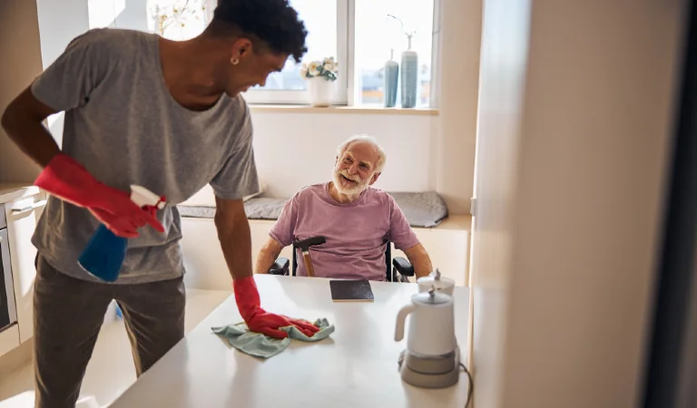 Young man doing the cleaning in the kitchen